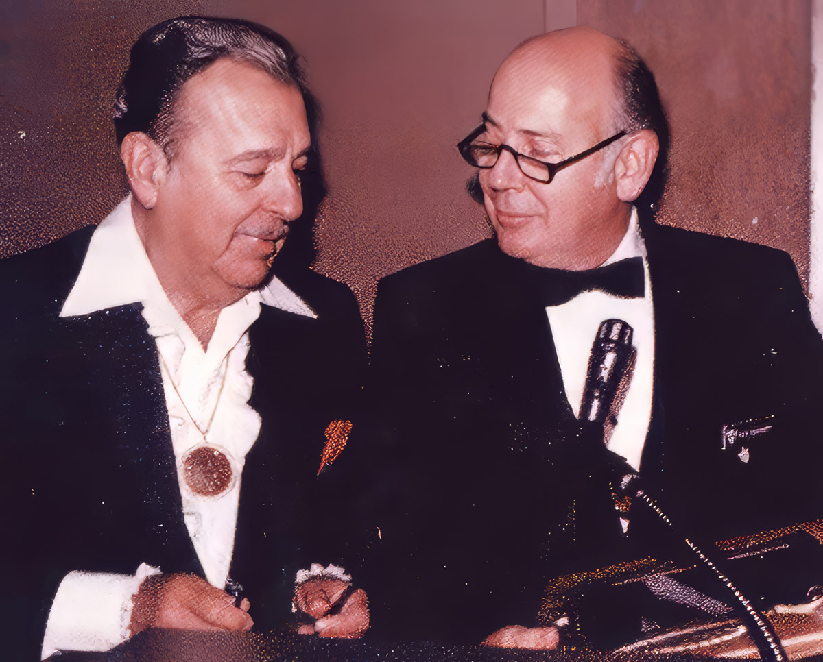 Gen. Russell E. Dougherty and Tennessee Ernie Ford together at a microphone.