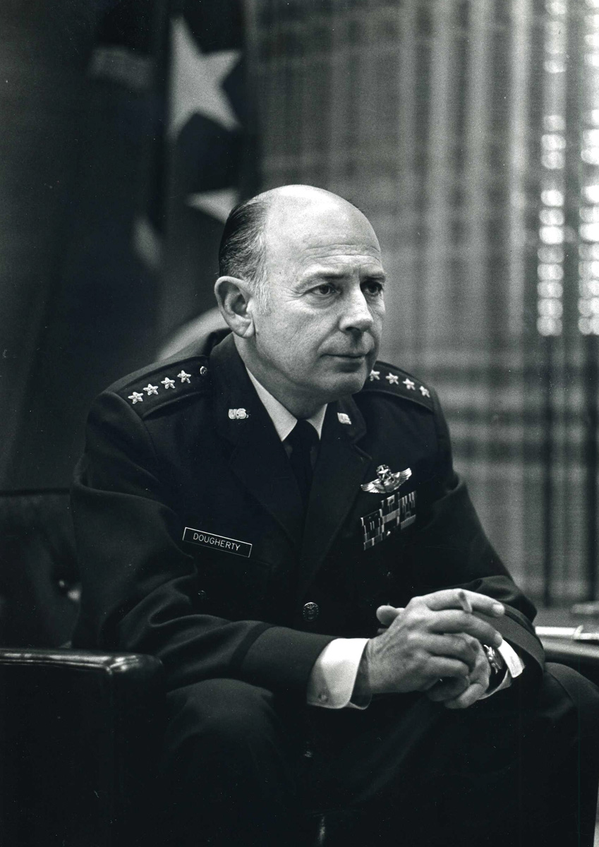 Gen. Russell E. Dougherty seated in his U.S. Air Force dress uniform.